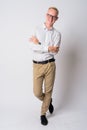 Full body shot of happy young blonde businessman smiling with arms crossed Royalty Free Stock Photo