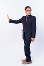 Full body shot of Japanese businessman showing stop gesture and looking away Royalty Free Stock Photo