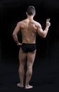 Full body shot of muscular young man seen from the back Royalty Free Stock Photo