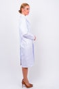 Full body shot profile view of blonde woman doctor as scientist Royalty Free Stock Photo