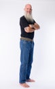 Full body shot profile view of happy mature bald bearded man looking at camera Royalty Free Stock Photo