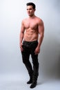 Full body shot of young handsome muscular man shirtless Royalty Free Stock Photo