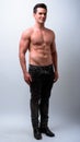 Full body shot of young handsome muscular man shirtless Royalty Free Stock Photo