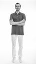 Full body shot of young happy bearded man smiling and standing with arms crossed against white background Royalty Free Stock Photo