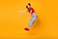 Full body side photo of jumping lady showing robot moves wear red crop top jeans shoes isolated yellow color background