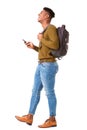 Full body side of happy young african american man walking on isolated white background with cellphone and bag Royalty Free Stock Photo