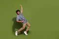 Full body size photo of funny crazy cool mexican guy pointing finger up seems like famous dancer star isolated on khaki Royalty Free Stock Photo