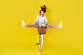 Full body size photo of insane young girl riding vintage unusual bike flying from hill carry flowers wind blow hair wear