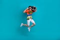 Full body size photo of jumping cool macho energetic guy sunglasses with boombox portable music player isolated on blue