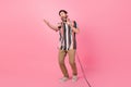 Full body size photo of professional singer brunet hair man loves music karaoke meloman dedicates song  on pink Royalty Free Stock Photo