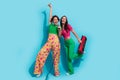 Full body size photo of two girlfriends old school boombox cassette recorder hand up rock roll singer isolated on blue Royalty Free Stock Photo