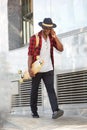 Full body smiling african man with skateboard talking on cell phone Royalty Free Stock Photo
