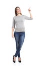 Full body of a standing casual woman pointing at side Royalty Free Stock Photo