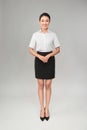 Full body studio shot of young beautiful business woman isolated on gray background Royalty Free Stock Photo