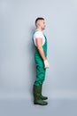 Full body vertical photo of virile guy self-confident skilled gardener ready start work listen customer order wear gum