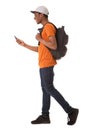 Full body young african american man walking on isolated white background with cellphone and bag
