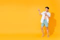 Full body of young handsome Asian man in casual summer outfit pointing hands to copy space aside