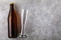 Full bottle of beer and empty glass on the table with copy space Royalty Free Stock Photo