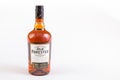 Full bottle of 100 proof whisky on a white background