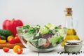 Full bowl of fresh green salad close up on a light table against a white background on a rustic kitchen. Concept helpful and simpl Royalty Free Stock Photo