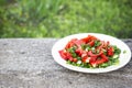 Full bowl of fresh vegetable salad on a wooden table. Royalty Free Stock Photo