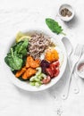 Full bowl healthy food - buckwheat, baked sweet potatoes, spinach, egg, beetroot, celery, tomatoes. Nutritious diet lunch