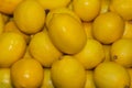 Full box juicy lemons. Yellow background. Royalty Free Stock Photo