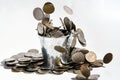 a full bucket of coins on white background. Money falling from the sky above. Selective focus. Royalty Free Stock Photo