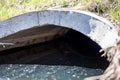 full capacity concrete culvert with sheen contaminated storm water runoff Royalty Free Stock Photo