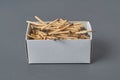 Full cardboard matchbox of many used matchsticks on dark concrete table on kitchen