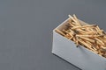 Full cardboard matchbox of many used matchsticks on dark concrete table on kitchen