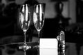 Full champagne glasses, antique keys and blank white card. Luxury hotel apartment Royalty Free Stock Photo