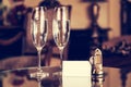 Full champagne glasses, antique keys and blank white card. Luxury hotel apartment Royalty Free Stock Photo