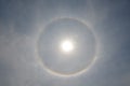 Full circle rainbow around Sun at noon, rays catch the thin vapour formed of ice crystals Royalty Free Stock Photo