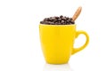 Full coffee beans in yellow cup