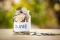 Full coins in a jar. Saving money concept and save money to support everything in life with sun light bokeh background