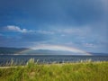 Full complete rainbow on a sunny summer day Royalty Free Stock Photo