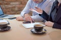 Full concentration at work. Group of young business people working and communicating while sitting at the modern  coffee shop Royalty Free Stock Photo