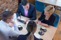 Full concentration at work. Group of young business people working and communicating while sitting at the modern  coffee shop Royalty Free Stock Photo