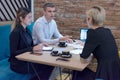 Full concentration at work. Group of young business people working and communicating while sitting at the modern  coffee shop Royalty Free Stock Photo