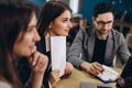 Full concentration at work. Group of young business people working and communicating while sitting at the office desk together Royalty Free Stock Photo