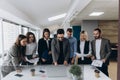 Full concentration at work. Group of young business people working and communicating while standing in modern office Royalty Free Stock Photo