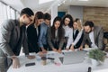 Full concentration at work. Group of young business people working and communicating while standing in modern office Royalty Free Stock Photo