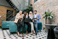 Full concentration at work. Group of young multiethnic business people, working and communicating while leaning together Royalty Free Stock Photo