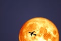 Full Crow Blood Moon and silhouette airplane flight on night sky Royalty Free Stock Photo