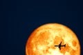 Full Crow Blood Moon and silhouette airplane flight on night sky Royalty Free Stock Photo