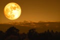 full crow moon back on silhouette cloud and mountain on night sky