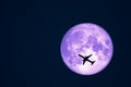 Full Crow Moon and silhouette airplane flight on night sky Royalty Free Stock Photo