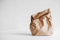 Full crumpled disposable bag of brown kraft paper on a white background. Copy, empty space for text