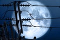 full crust moon back on silhouette power electric line on night sky Royalty Free Stock Photo
